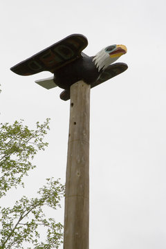 Eagle on top of  totem pole of Saxman Nature Village Ketchikan