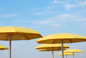 yellow umbrellas against blue sky