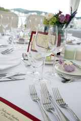 Wedding table arrangement with flowers and seating list