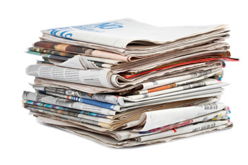 A stack of local newspapers with focus on front. Shallow DOF