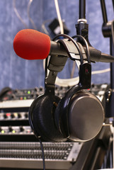 Microphone with head phones in broadcasting station