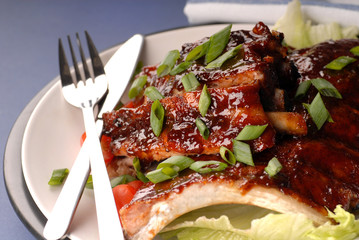 A slab of BBQ ribs with scallions