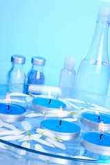 Candles and petals floating in a glass bowl