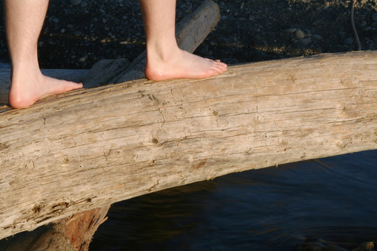 feet balancing on log