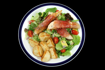 Chicken tenderloins wrapped in prosciutto with a garden salad.