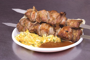 fried meat, sauce and vegetables on a dish