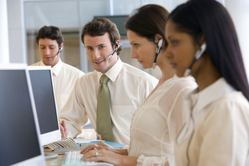 Call center with focus on young man