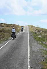 two cyclist cycling uphill