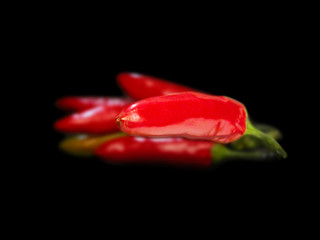 Red hot chili peppers closeup on black background