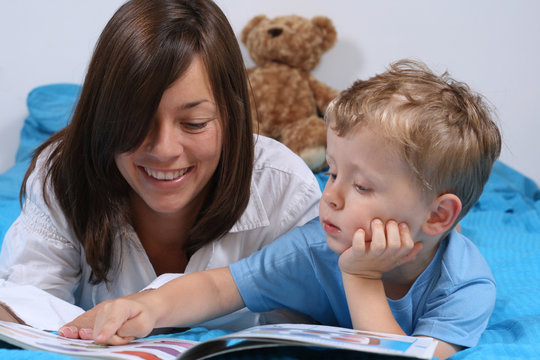 Mother And Three Years Old Boy Reading Book - Good Night