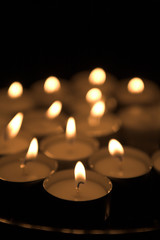 set of candles all lit over black background