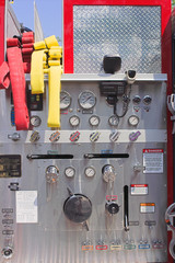 The ladder controls and hoses on a firetruck.