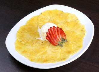 dessert pineapple with strawberries and icecream