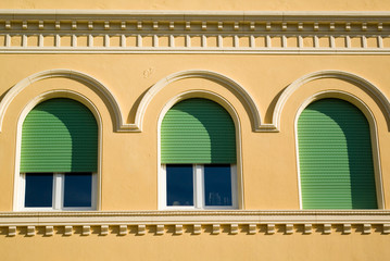 close up of a row of window of an italian old style house