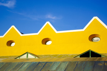 Roof detail of a modern building against blue sky.