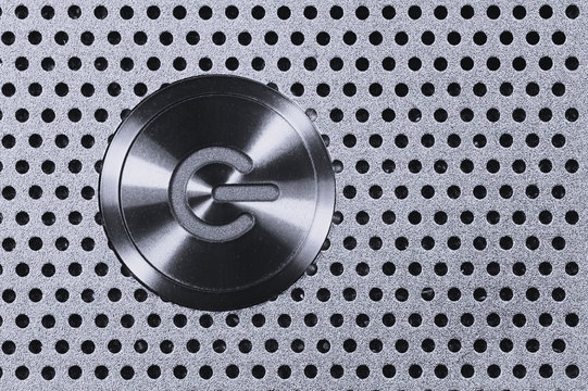 Power Button on Metal Hole Background.