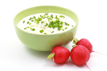 bowl of cottage cheese with chive and radish isolated on white