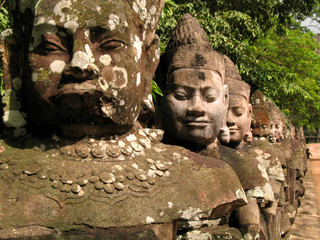 Statues of gods outside the gateway to angkor wat temple