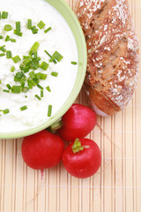 bowl of cottage cheese with chive radish and bread