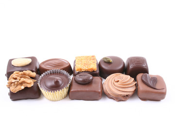 close-ups of mixed chocolates isolated on white