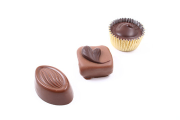close-ups of mixed chocolates isolated on white