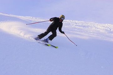 Mountain-skier sliding on the flank of hill