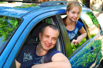 Father and daughter sitting inside the car 