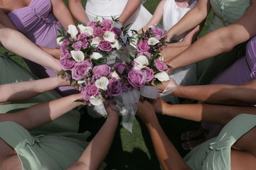 wedding flowers and bridesmaids arms