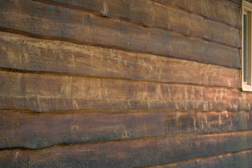 the side of a rustic wood sided house