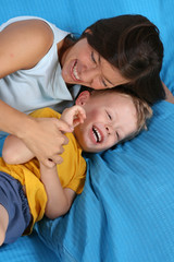 mother and three years old boy in bedroom