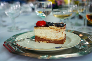 Dark chocolate mousse cake with cream and a strawberry