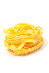 A uncooked pasta nest with soft shadow on white background