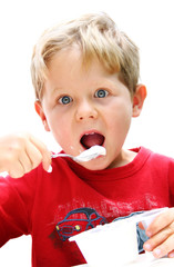 Four year old boy eating yogurt.
