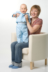 Mother and her baby sitting on chair