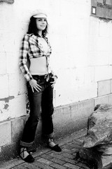 girl hanging out on a white brick wall