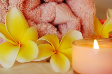 spa image of frangipani flowers and candles
