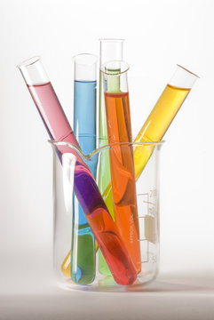 Glass beaker and test tubes filled with colorful liquids