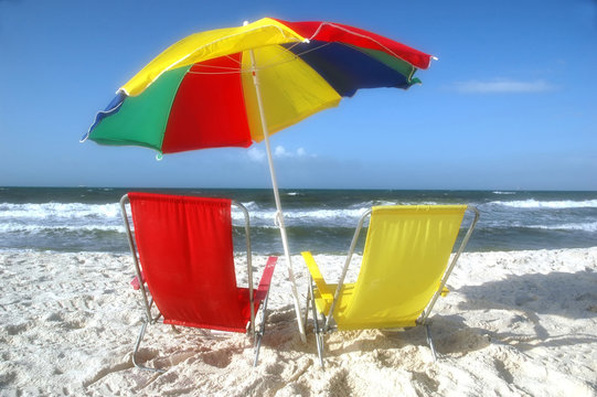 Beach scene with beach chairs and unbrella.