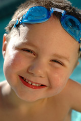 Happy toddler in diving goggles; tight headshot