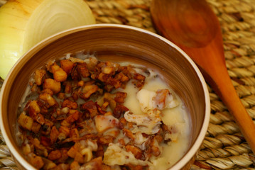 Greaves lard with onion and wooden spoon