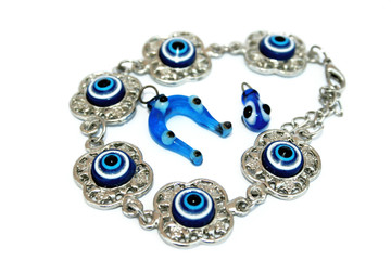 Metallic bracelet and medallions with blue eyes 