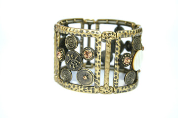 Metallic ancient style bracelet with ornaments and stones.