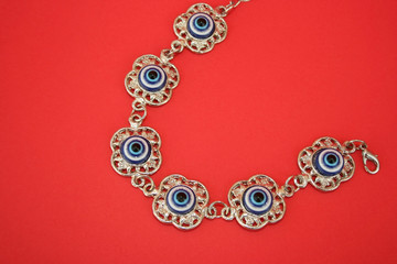 Metallic bracelet talisman with blue eyes for helping.