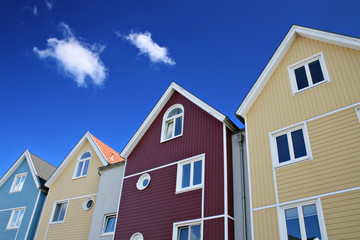 Four colorful houses with blue sky