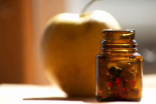 An image of a glass with pills lko