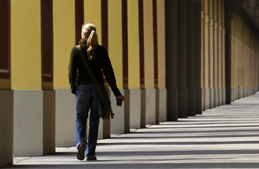 A carefree student walking among university columns