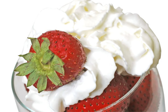 Strawberries and whipped cream in glass. Clipping path.