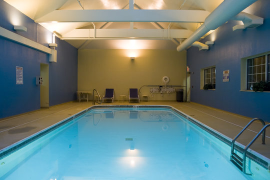 Wide angle view of an indoor swimming pool in a hotel