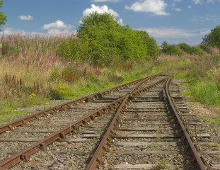 Obraz premium An old rusty railway track, curving into the distance