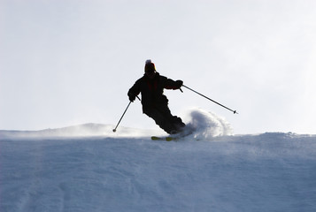 Mountain-skier sliding on the flank of hill